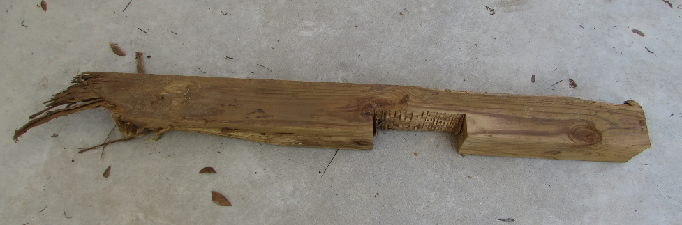 (image: bottom of 4x4 pressure-treated fencepost, with a square notch
  that goes about halfway through)